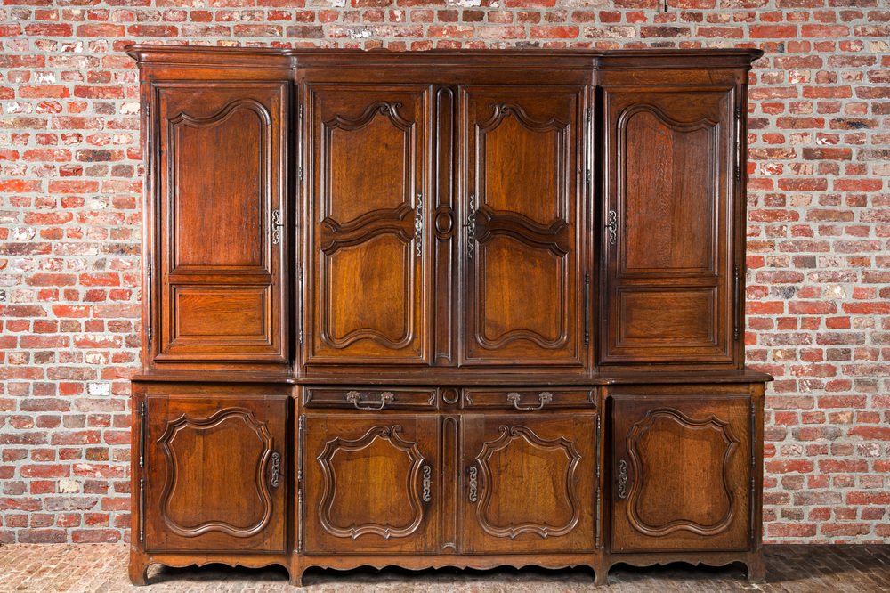 A large French oak two-part cupboard with eight doors and two drawers, Lorraine region, 18th C.