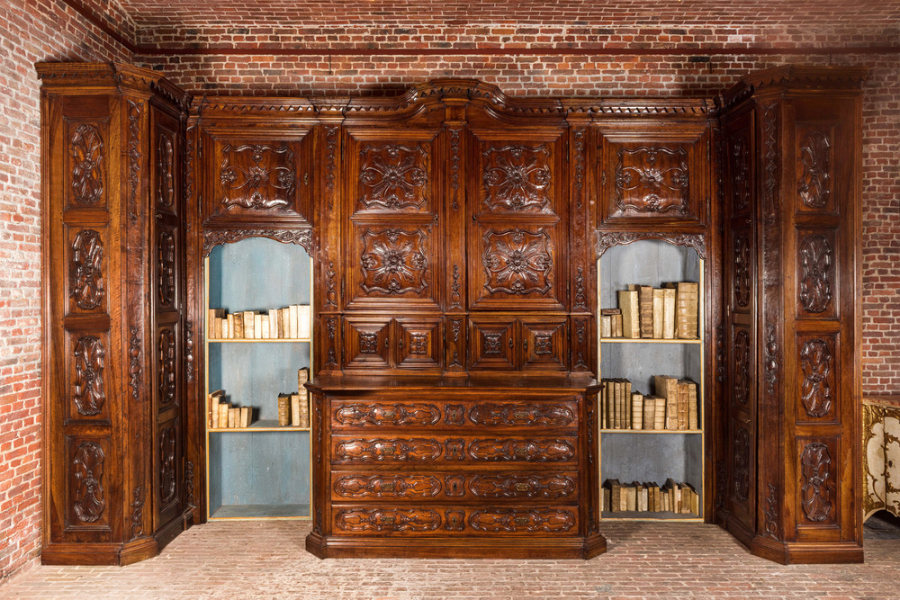 An imposing walnut sacristy cupboard with floral design and garlands, 18th C.