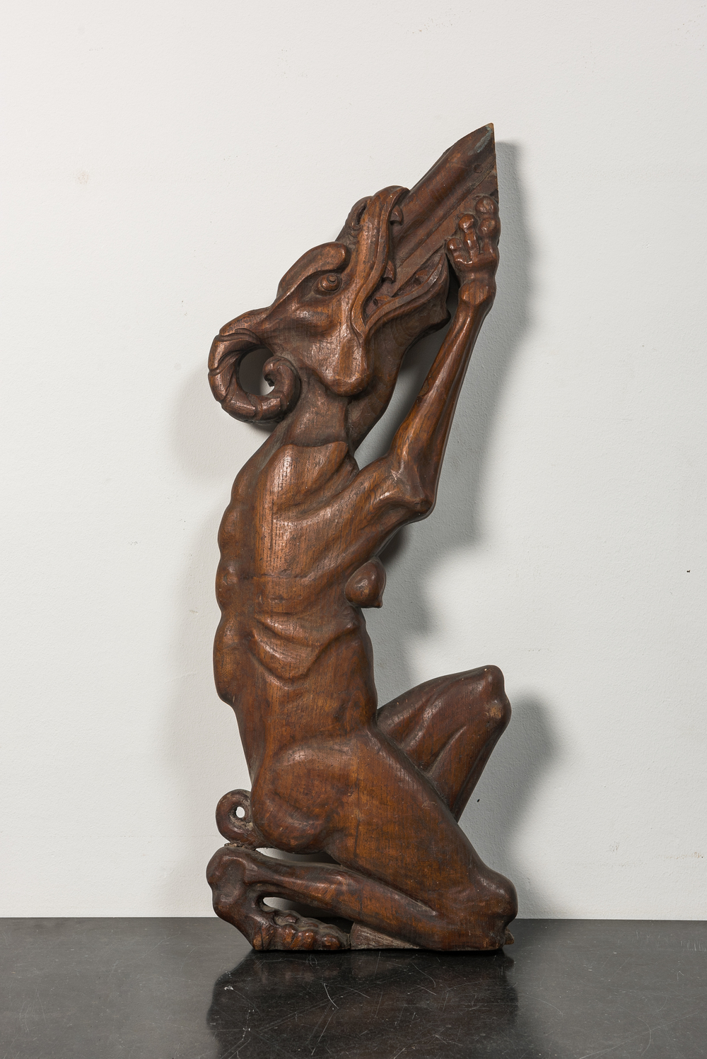 A carved wooden balustrade fragment in the shape of a female dragon, 19th C.