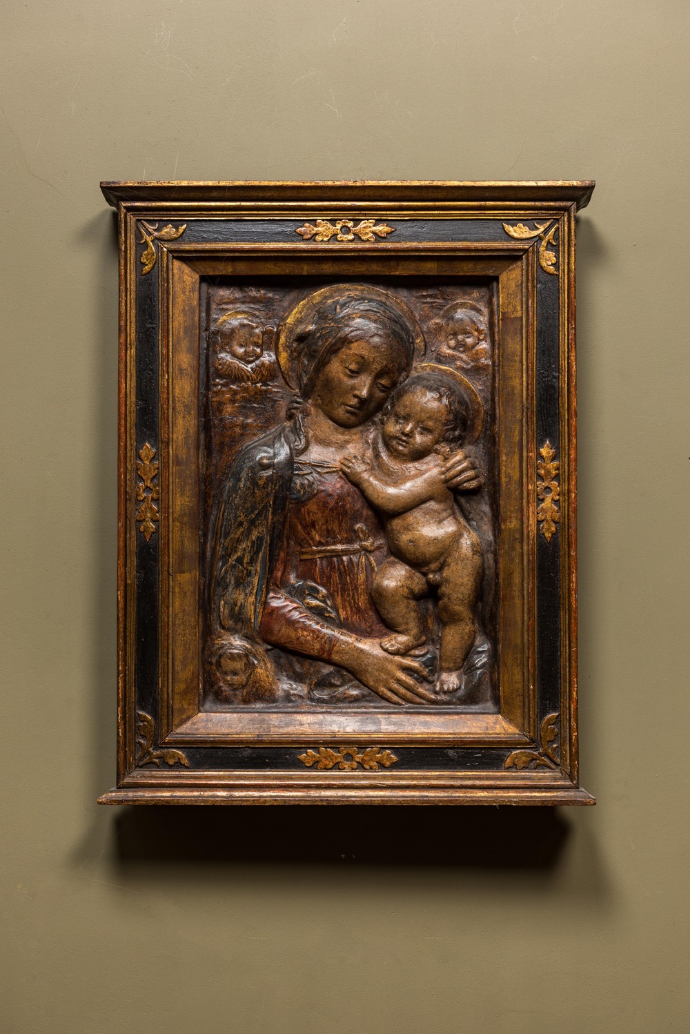 An Italian polychrome stucco relief with Madonna with Child, possibly Florence, 16/17th C.