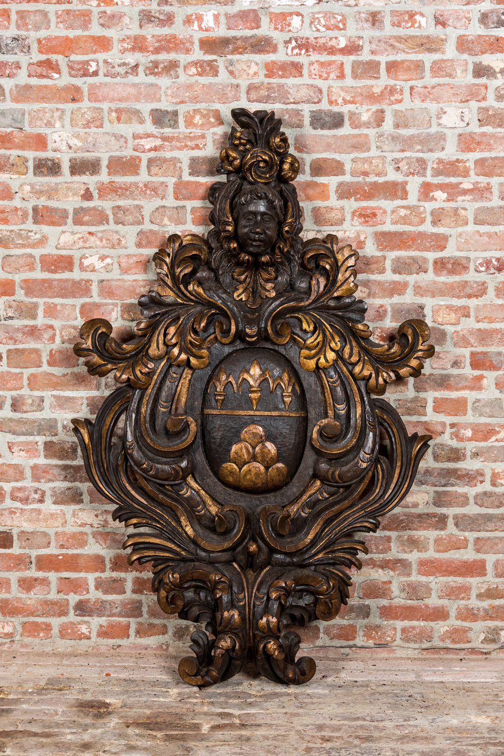 A large partly gilt wooden armorial carving, Italy, 19th C.