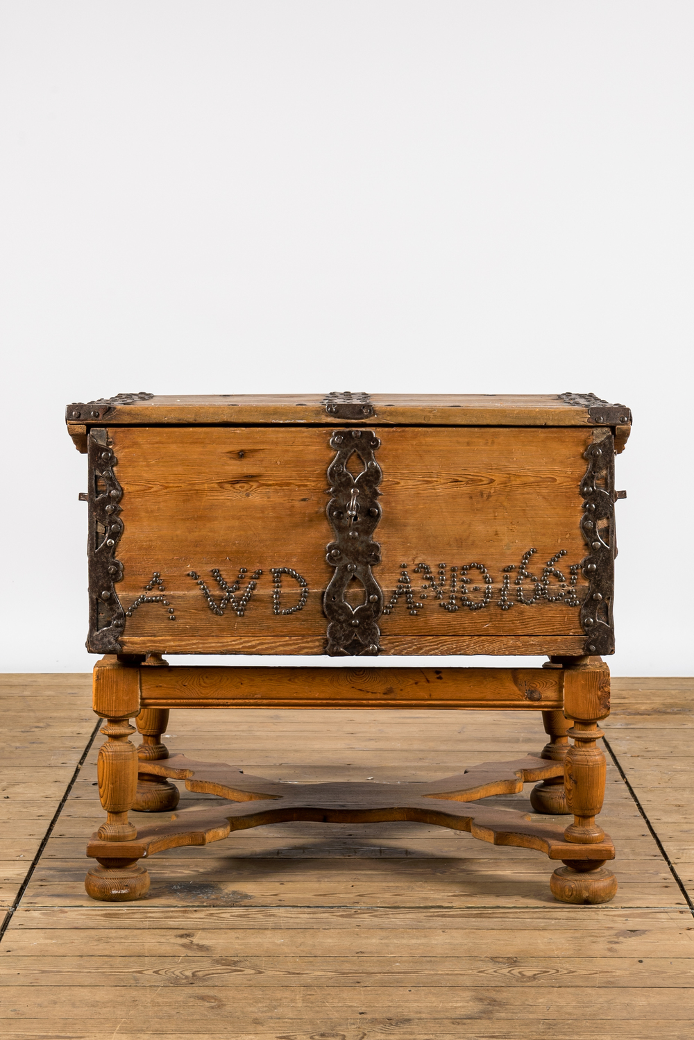 An iron-mounted pine chest on foot, dated 1661, 17th C. and later