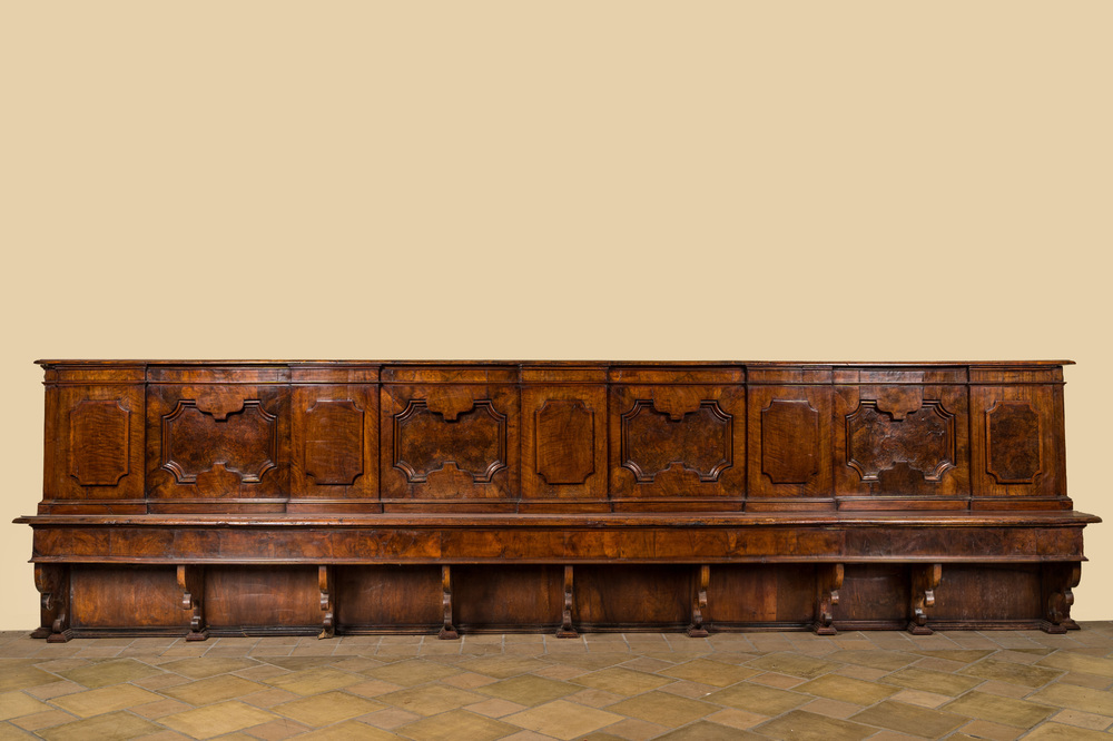 An impressive large Italian walnut and root wood veneer bench with geometric decoration of molded panels, 17th C.