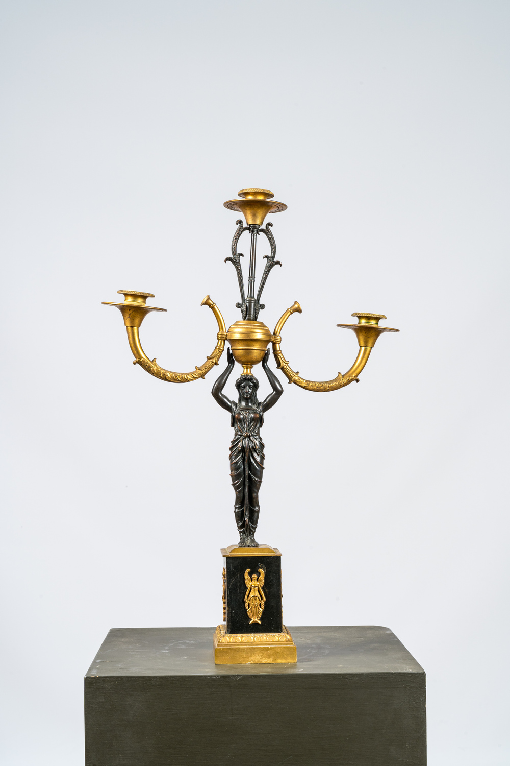 A French gilt and patinated bronze three-light candelabra, 19th C.