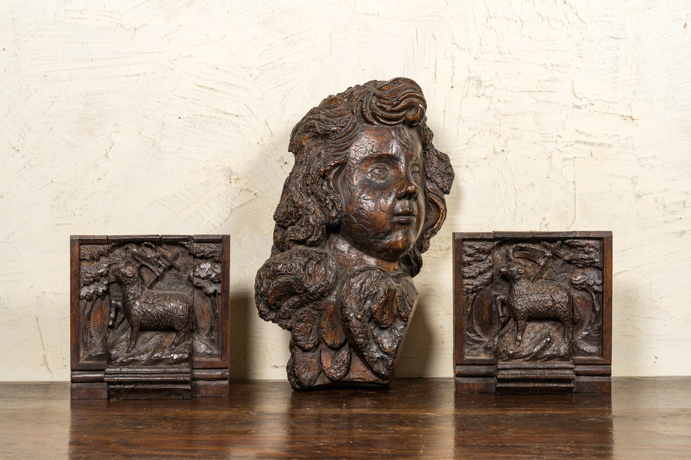 A carved oak cherub's head and a pair of 'Lamb of God' panels, 17th C.