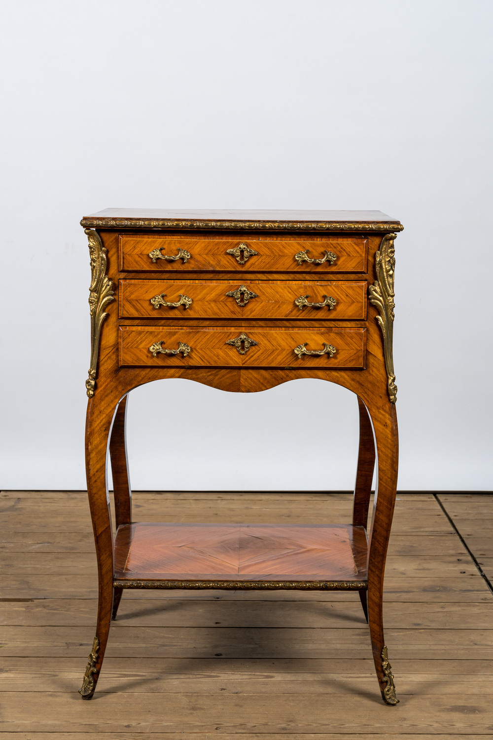 A French gilt bronze mounted three drawer side table, 19/20th C.