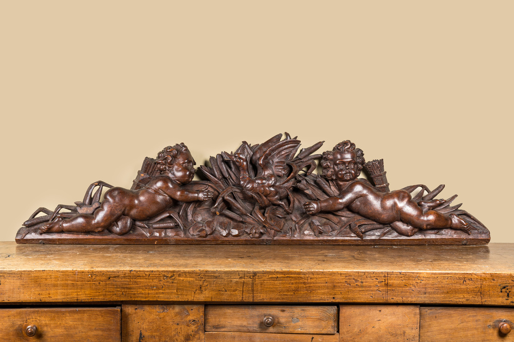 A carved oak fronton with two angels around a central duck, late 18th C.