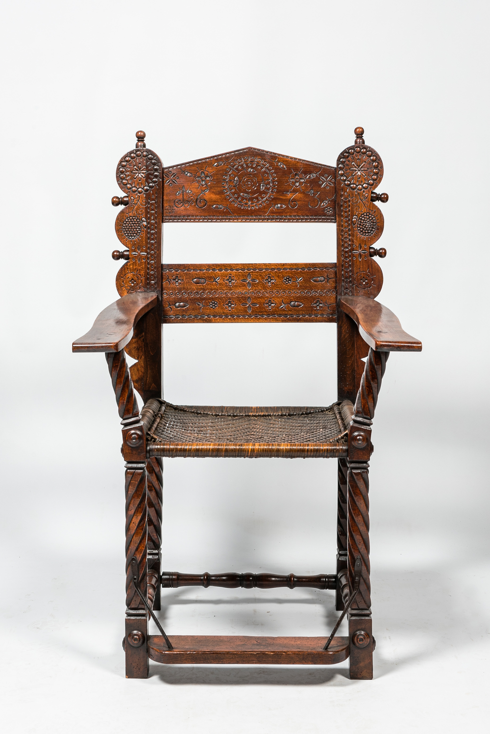 A walnut armchair with wicker upholstery, 19th C.