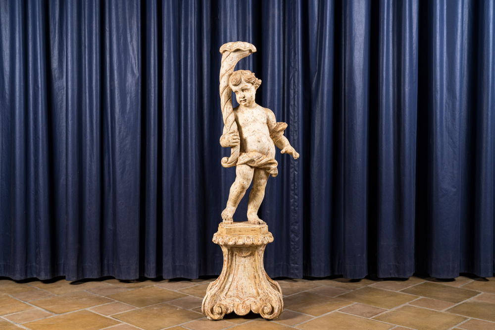 A large white patinated wooden putto holding a cornucopia, 18th C.