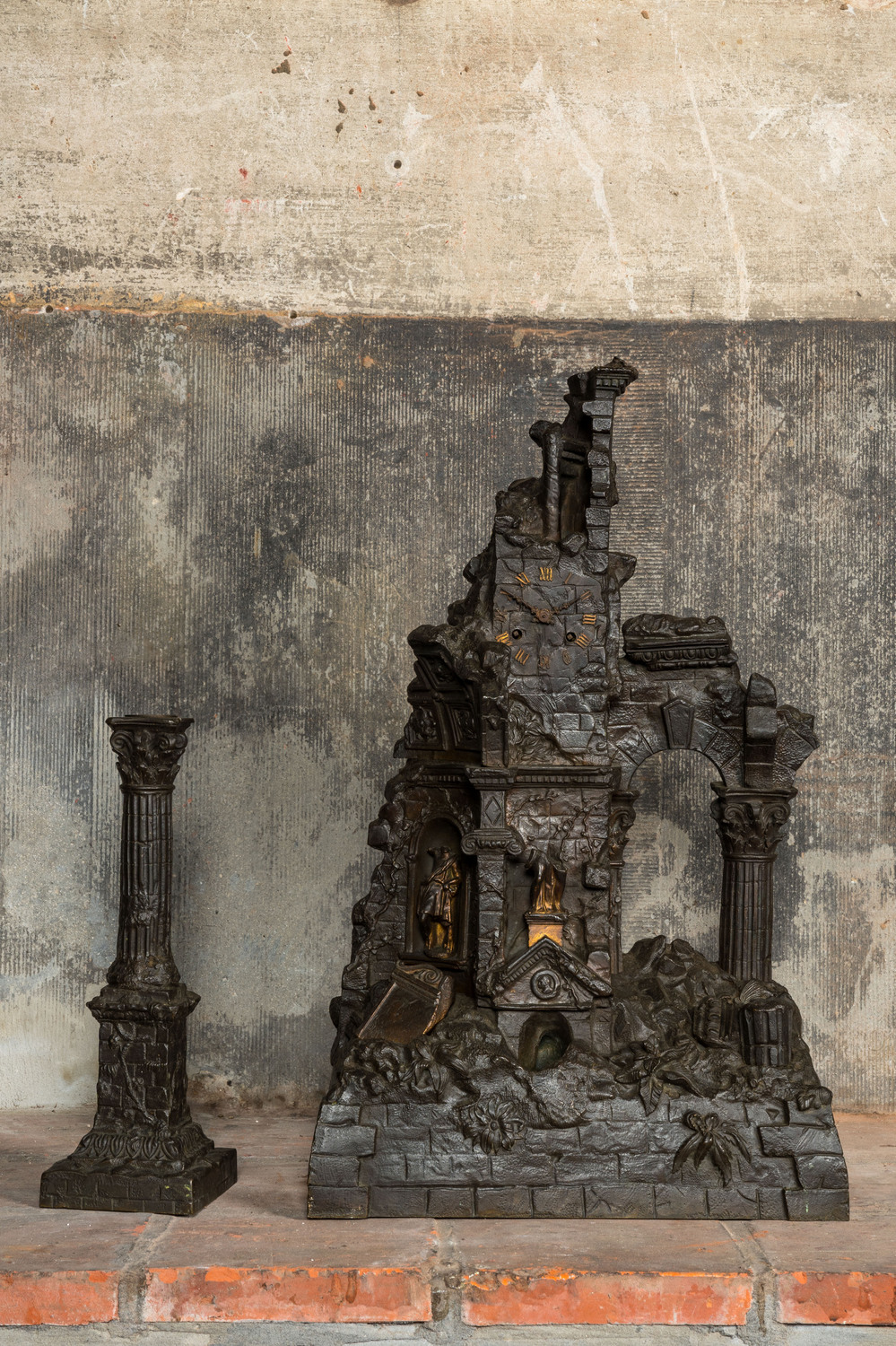 A French patinated and gilt bronze 'ruin' clock with matching candlestick, 19th C.