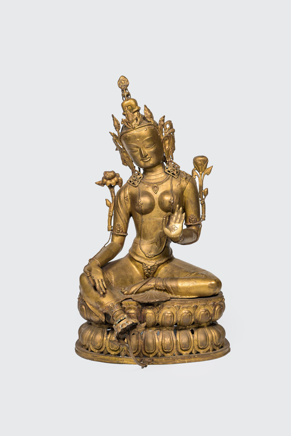 A large gilt copper figure of Tara seated on a lotus throne, India or Nepal, 20th C.