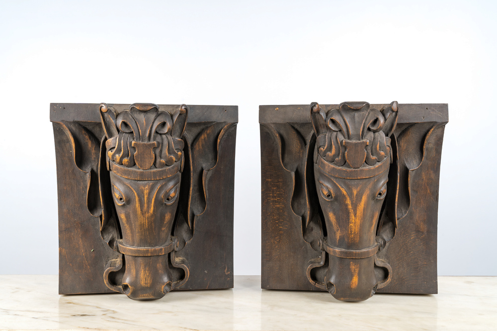 A pair of patinated wooden wall consoles with a horse's head, 20th C.