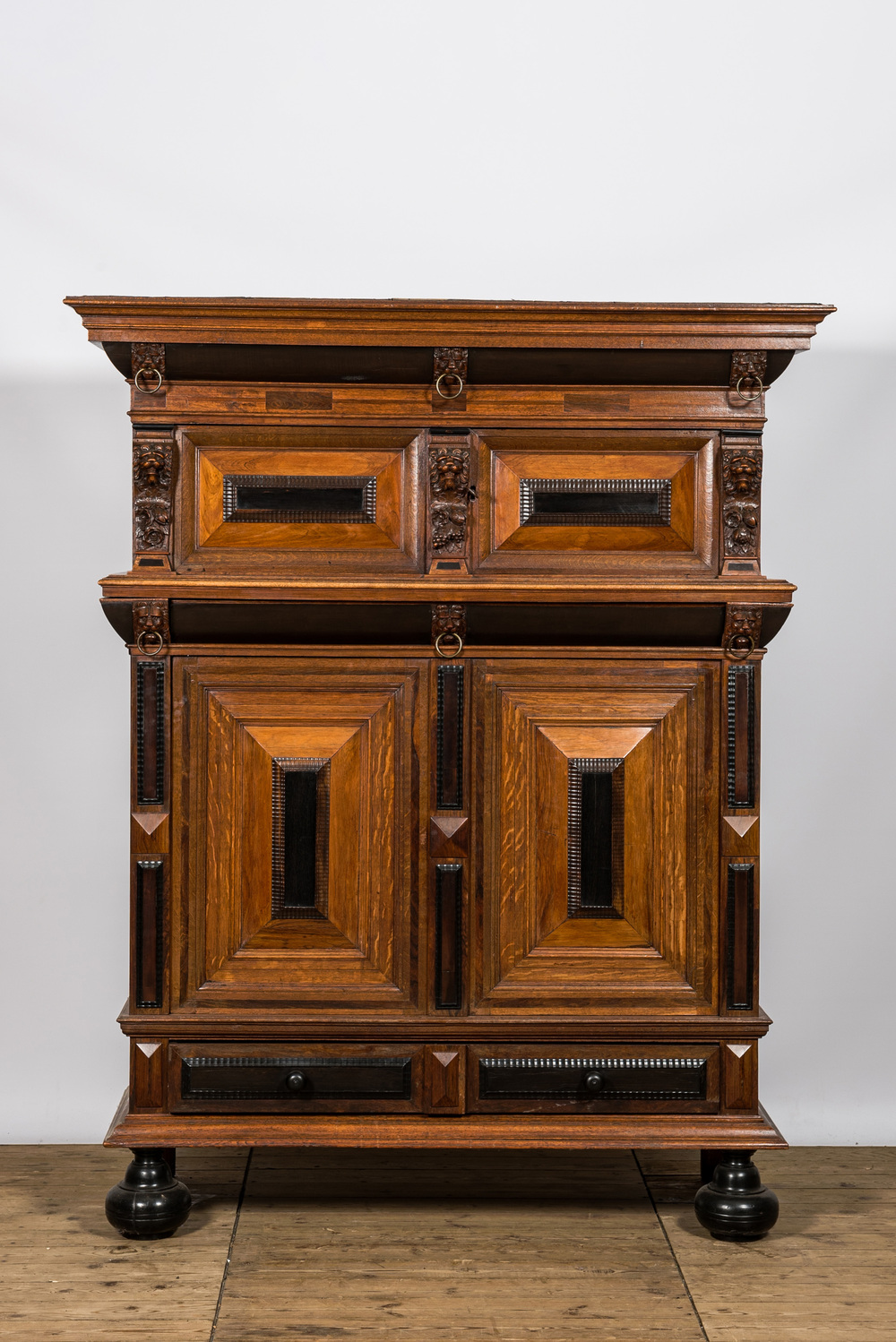 A Dutch partly ebonised oak four-door cupboard, 19th C.