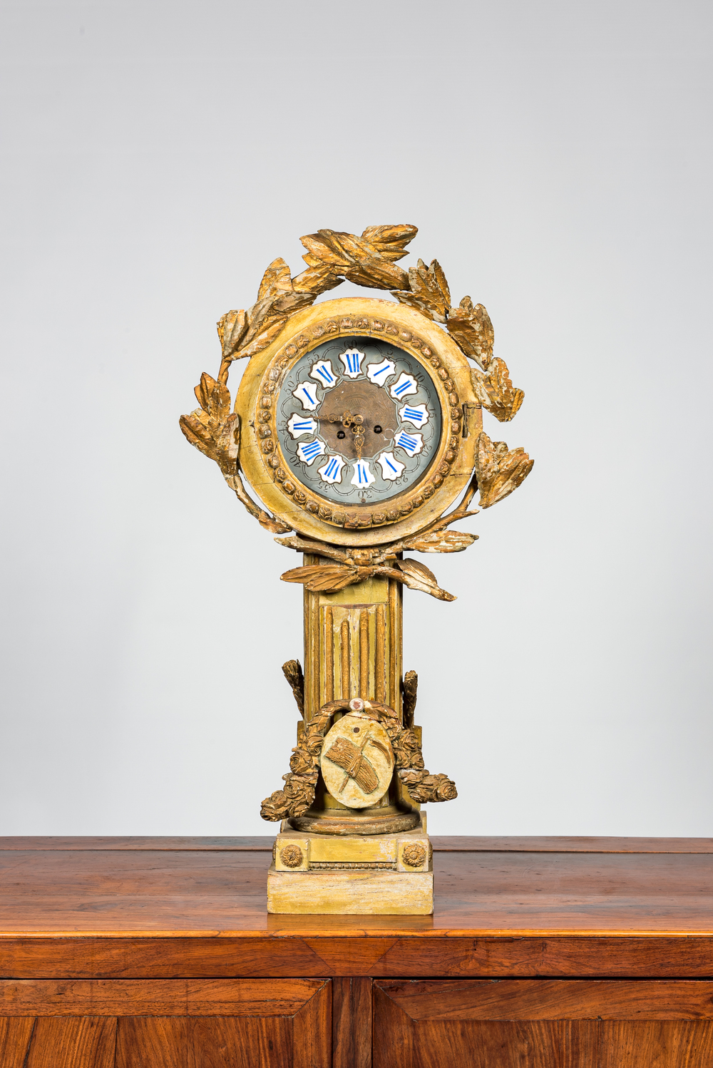 A French polychromed and gilt wooden portico clock on column with harvest design, 18th C. and later