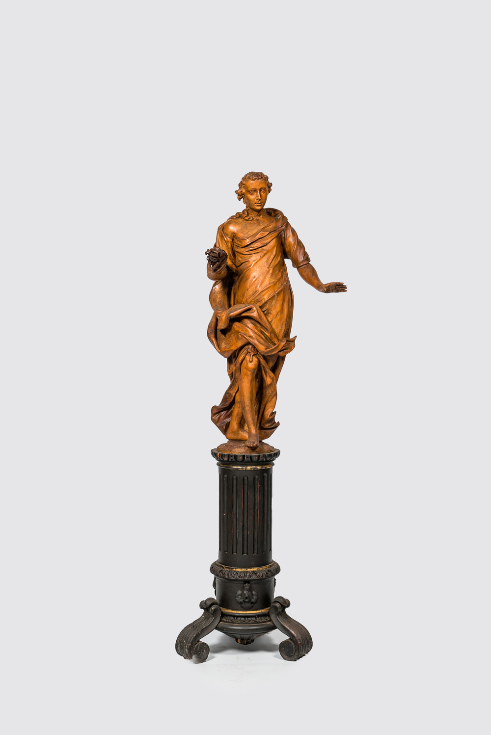 A basswooden allegorical 'Spring' figure on an ebonised neoclassical wooden base, 18/19th C.