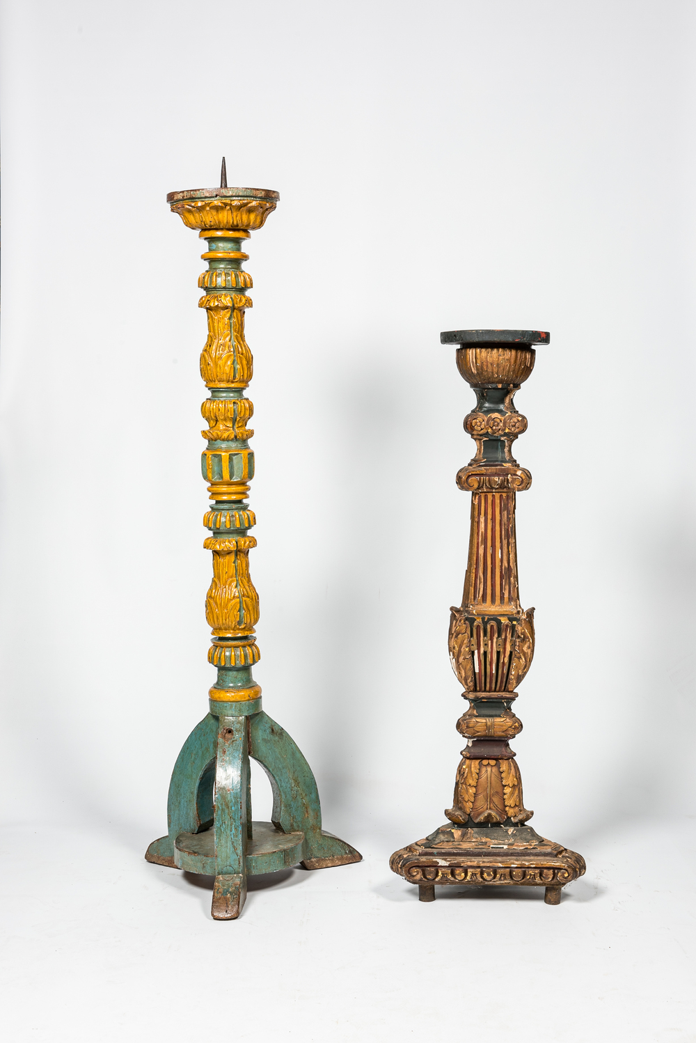 A polychromed wooden 'torch&egrave;re' and a large candlestick, 18th and 19th C.