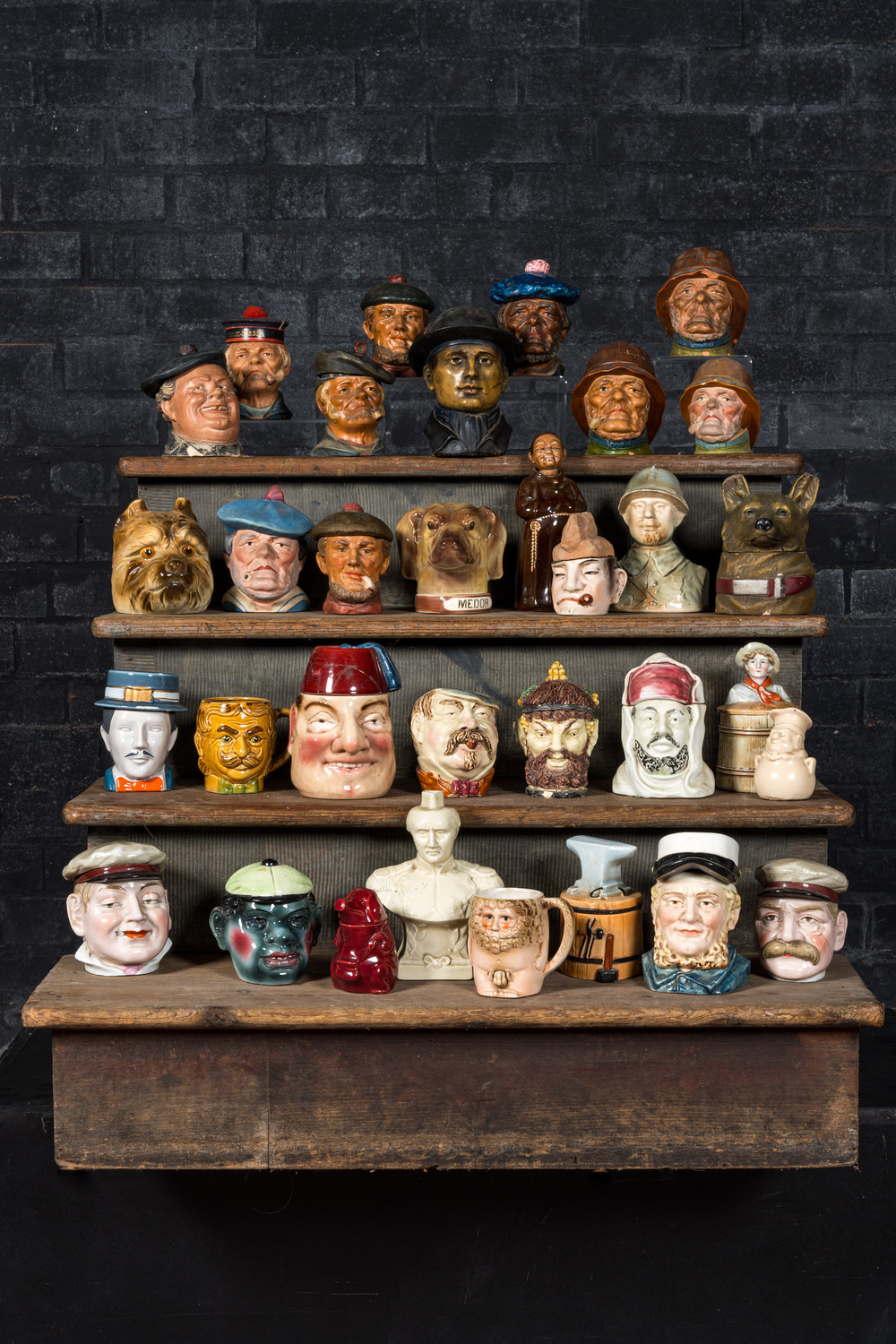 A collection of barbotine tobacco jars in the shape of heads of men and animals, 19/20th C.