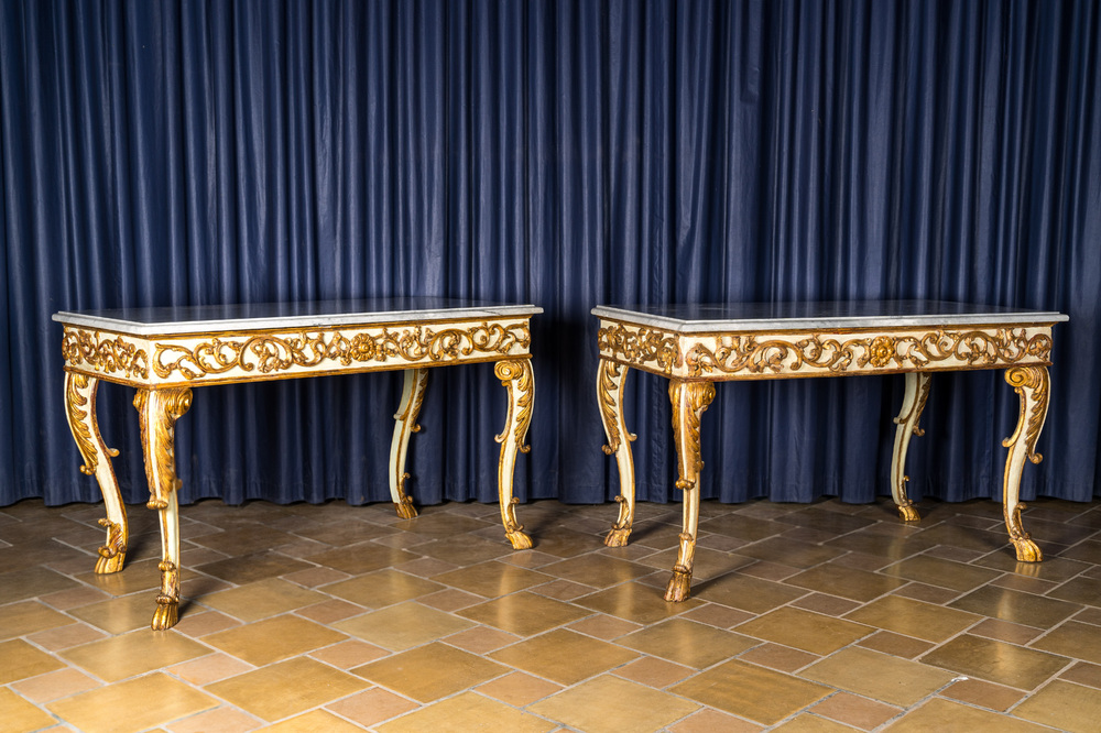 A pair of Italian patinated and gilt wooden wall consoles with marble top, 18th C.