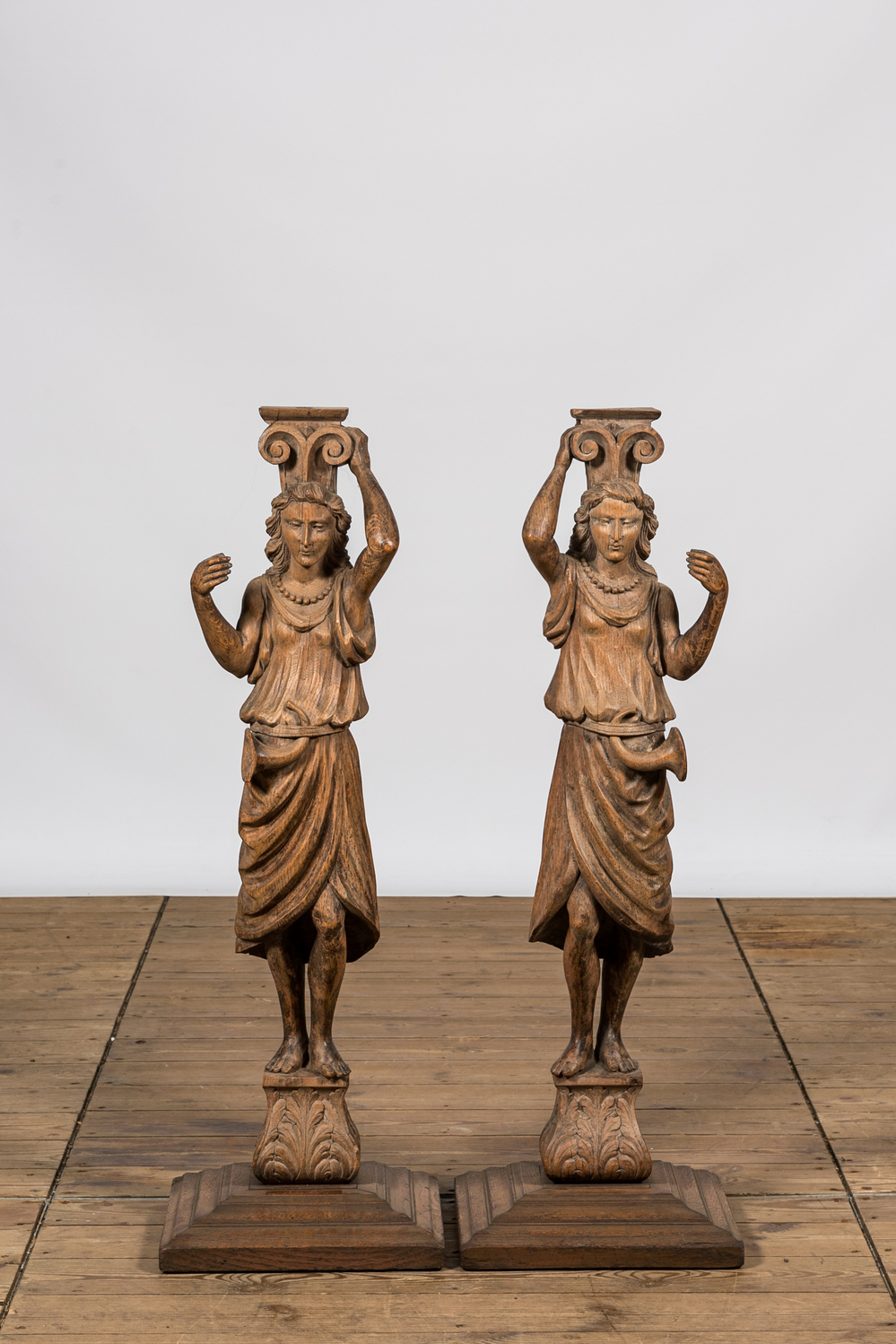 A pair of oak wooden caryatids on foot, 19th C.