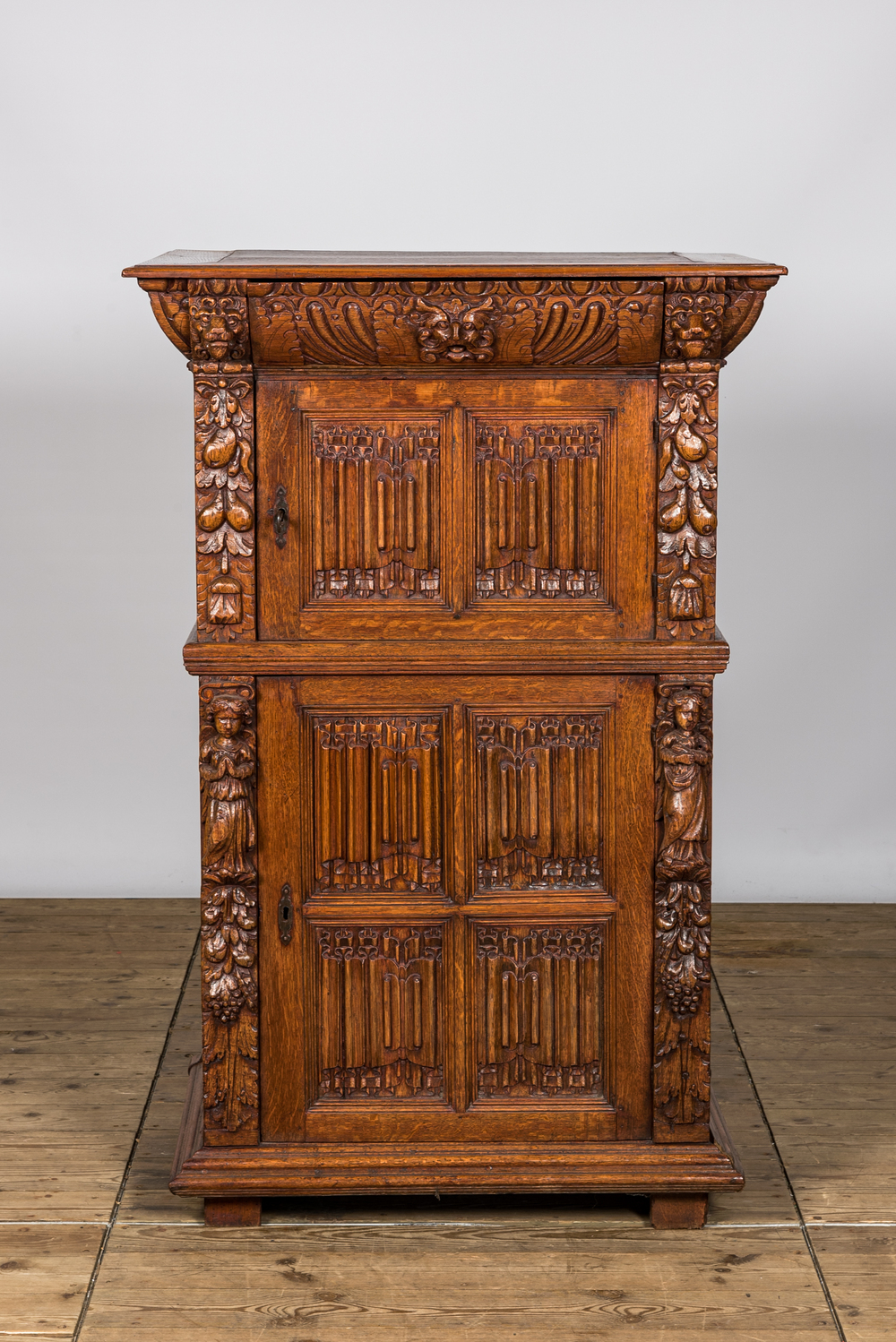 A Gothic Revival oak two-door cupboard with linenfold panels, 19th C. with older elements