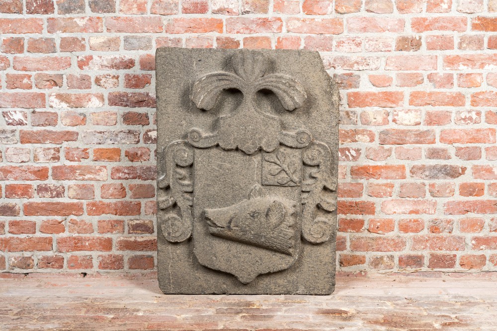 A carved stone relief with a coat of arms with the head of a wild boar, 19th C.