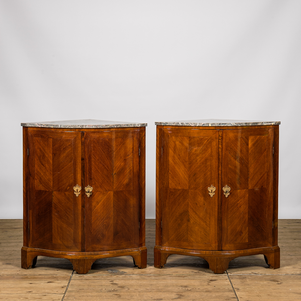 A pair of French mahogany corner cabinets with marble tops, 18/19th C.