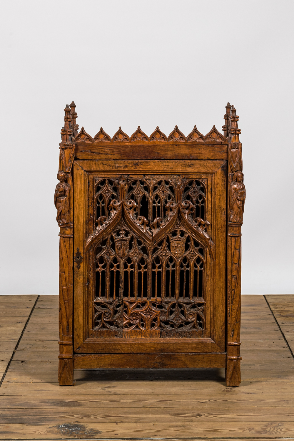 An attractive reticulated gothic wooden panel mounted in a Gothic Revival cabinet, 16th and 19th C.