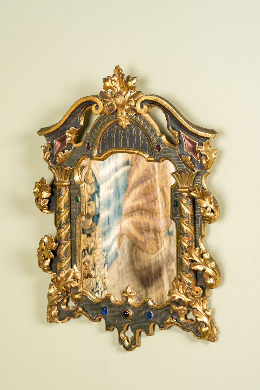 A painted and partly gilt carved wooden 'columns' mirror with cabochons, 19/20th C.