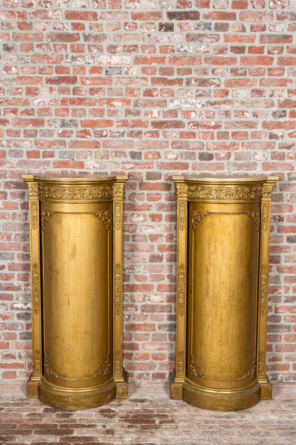 A pair of gilt wooden Empire-style demi-lune cabinets, ca. 1900