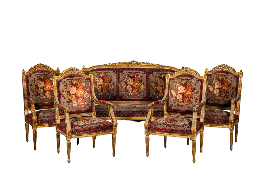 A neoclassical gilt wooden salon set comprising a sofa and four armchairs, 20th C.