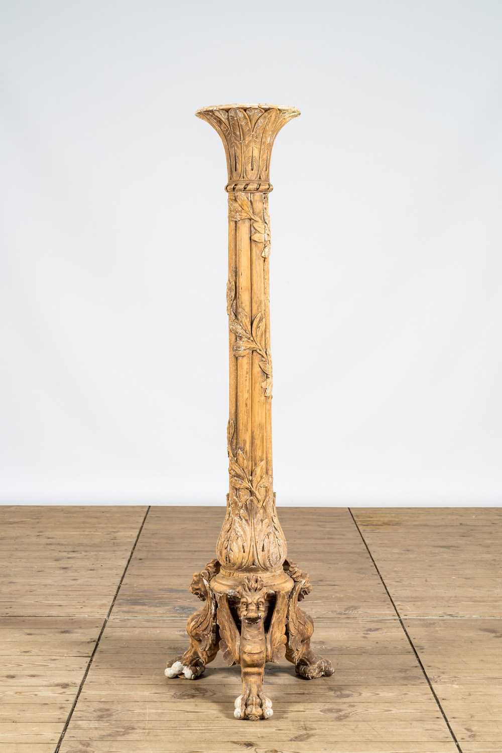 A large wooden column resting on dragon feet, 19th C.