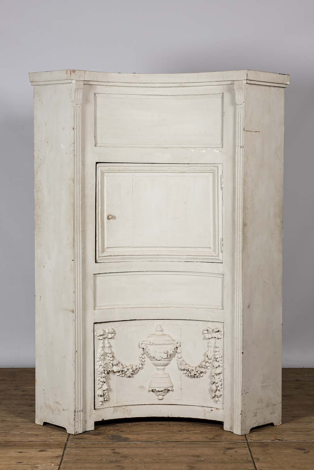 A neoclassical whitewashed corner cabinet, 19th C.