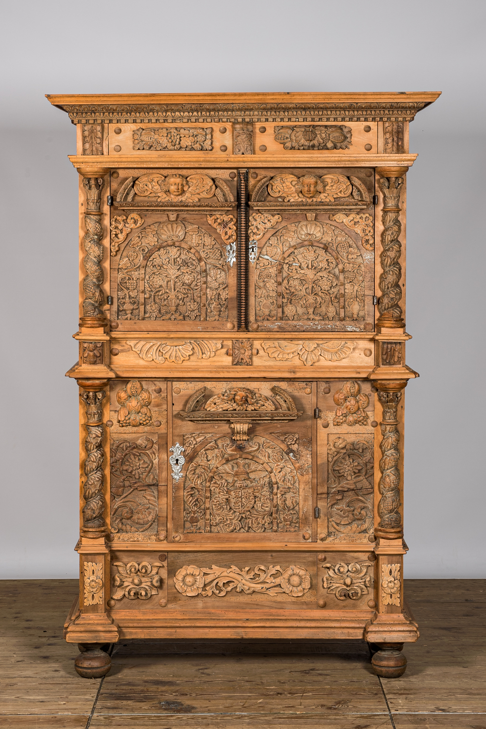 A German baroque leached walnut three-door cabinet, 18th C. with later elements