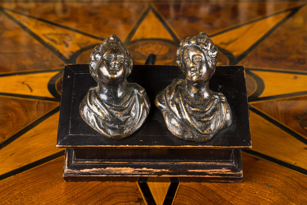 A pair of Italian patinated bronze miniature busts mounted on a later ebonised wooden stand, 17th C.