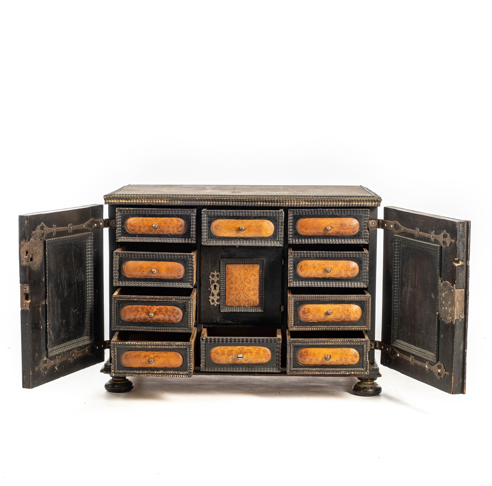 An ebonised and inlaid wooden cabinet, 19th C.