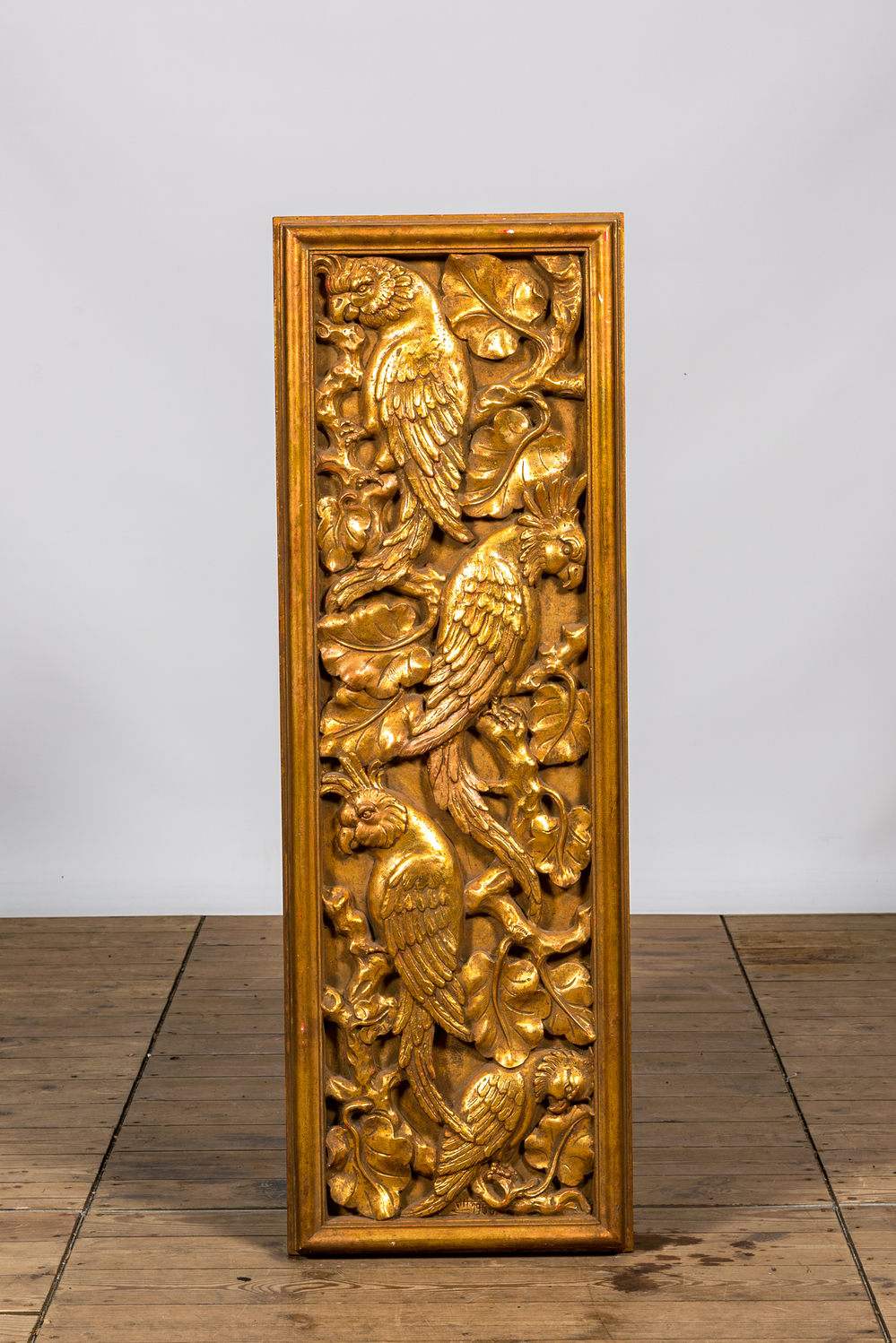 A gilt plaster relief with macaws, 20th C.