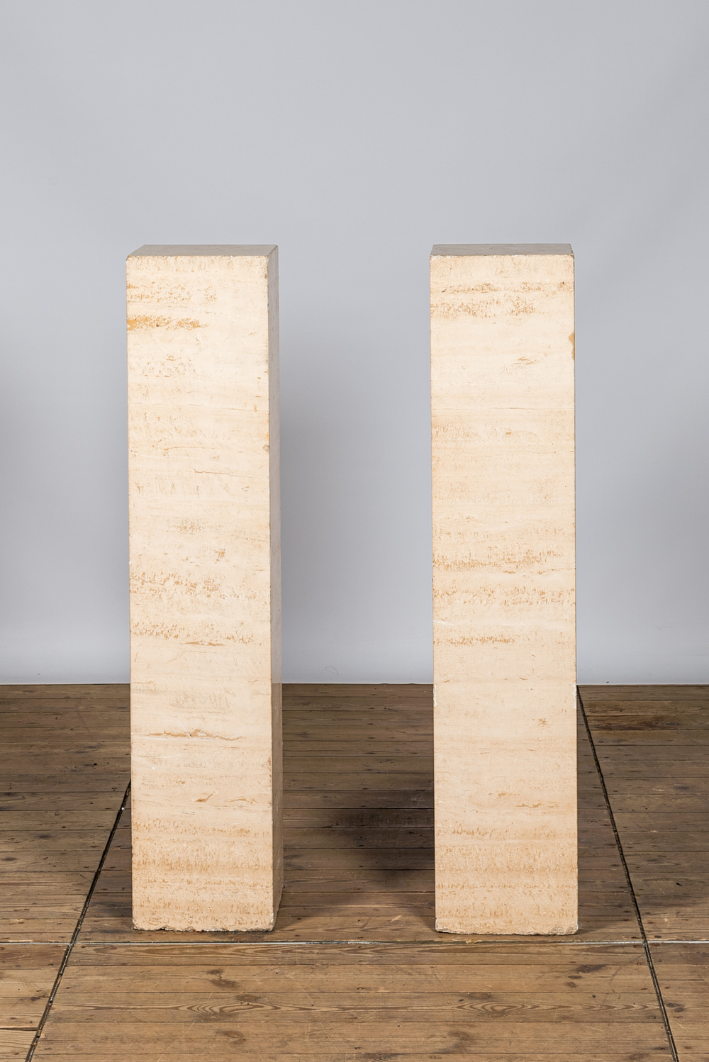 A pair of Italian travertine pedestals, 20th C.