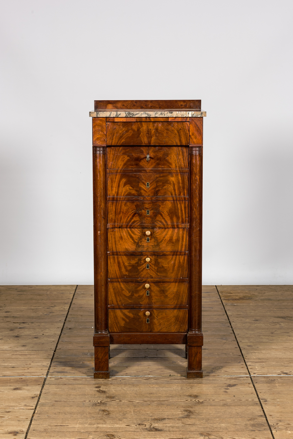 A mahogany 'semainier' with marble top, 19th C.