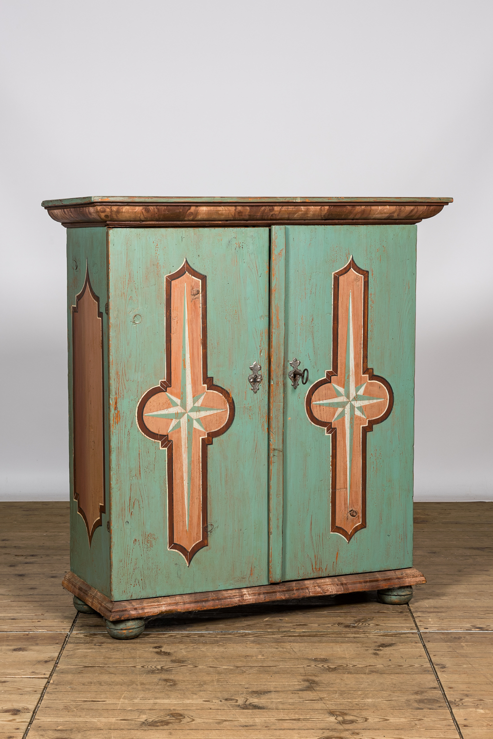 A polychrome wooden two-door cabinet with inside landscape design, 19th C.