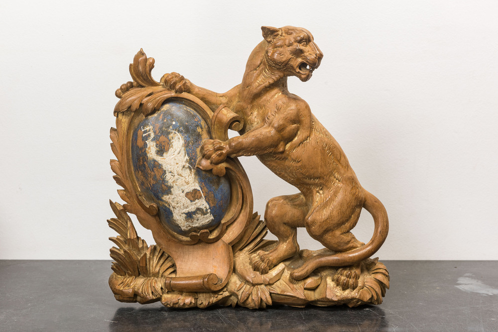 Een houten reli&euml;f met een tijger die een schild vasthoudt, 19e eeuw