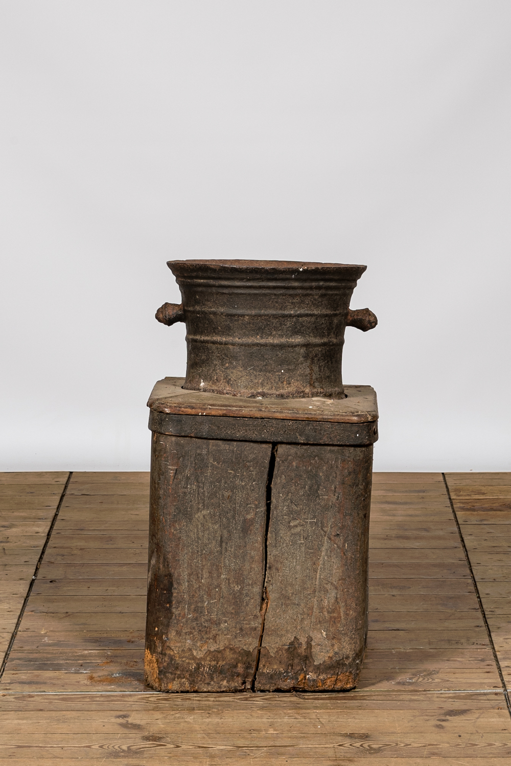 A large iron mortar on wooden stand, 17th C.