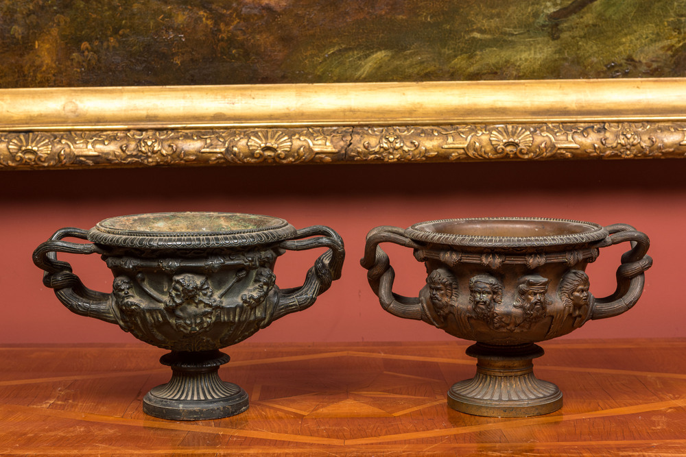 Two bronze jardini&egrave;res with molded design of men's heads, 19th C.