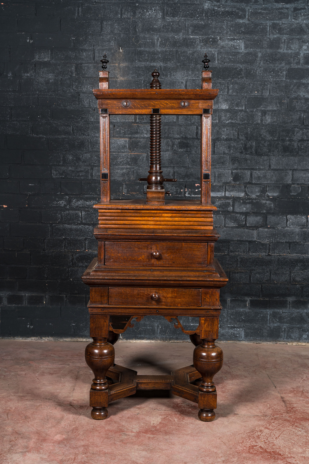 An oak linen press on foot with ebonised accents, 19th C.