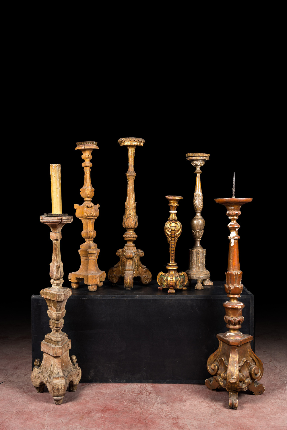 Six large partly gilt and painted wooden candlesticks, 18/19/20th C.