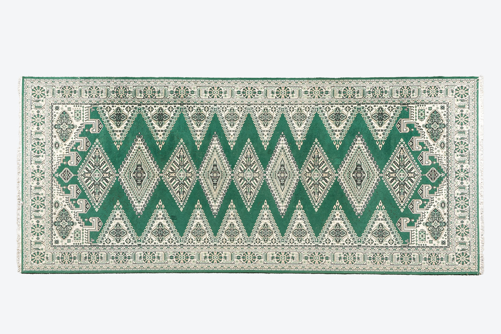 An Oriental rug with geometric motifs, wool on cotton, 20th C.