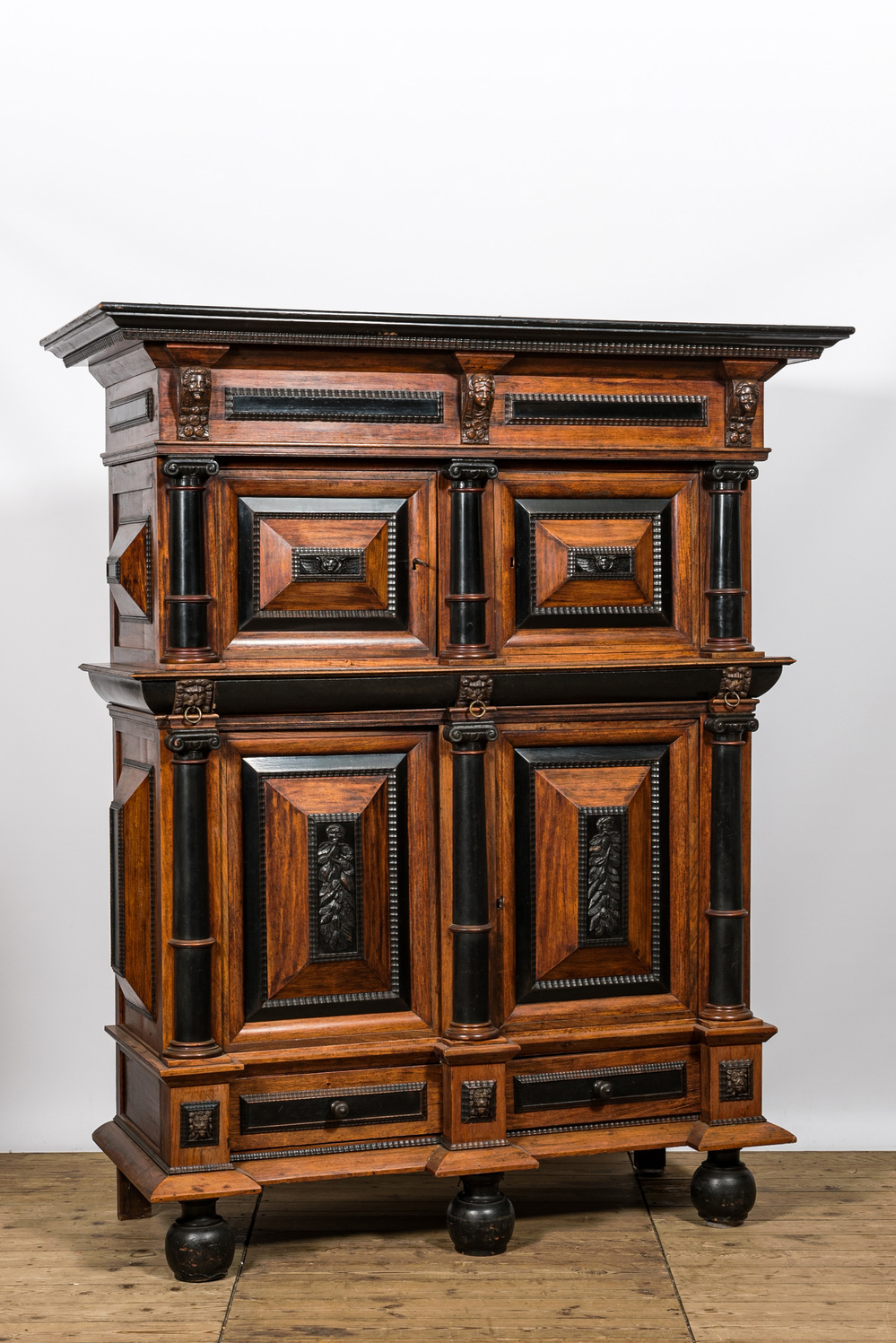 A Dutch partly ebonised wooden four-door cupboard, 19th C.