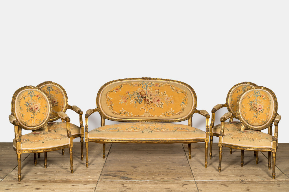 A French five-piece gilt wooden salon set comprising a sofa and four armchairs with embroidered upholstery, 19th C.
