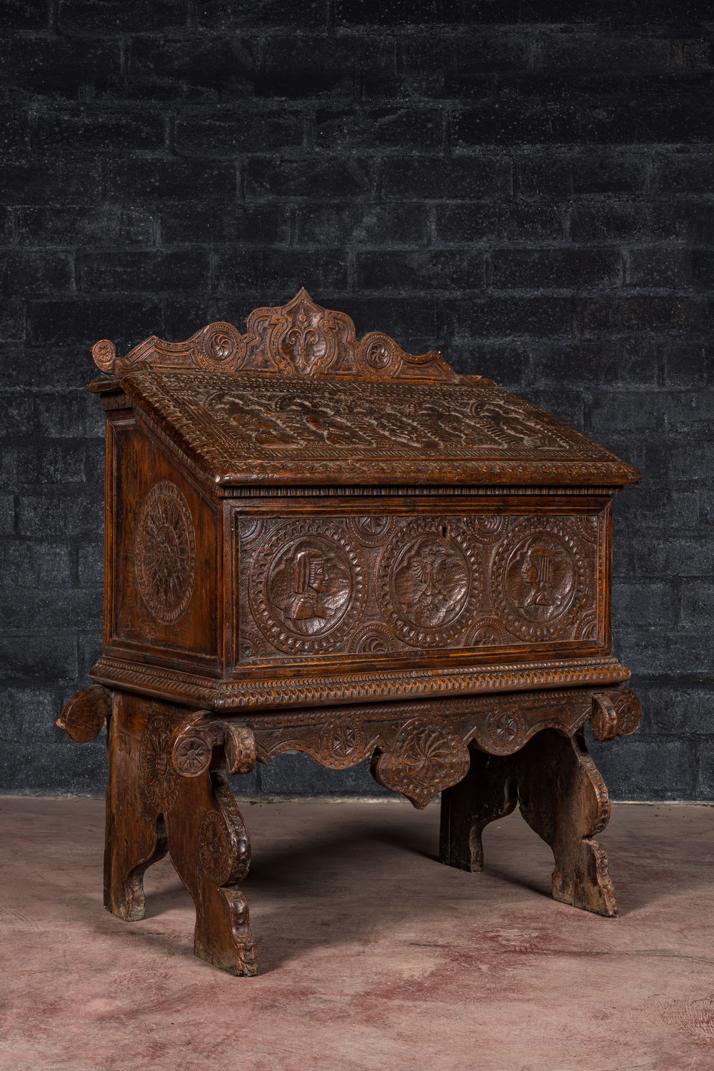A walnut cassone or marriage chest on stand, probably Italy, 19th C. with older elements