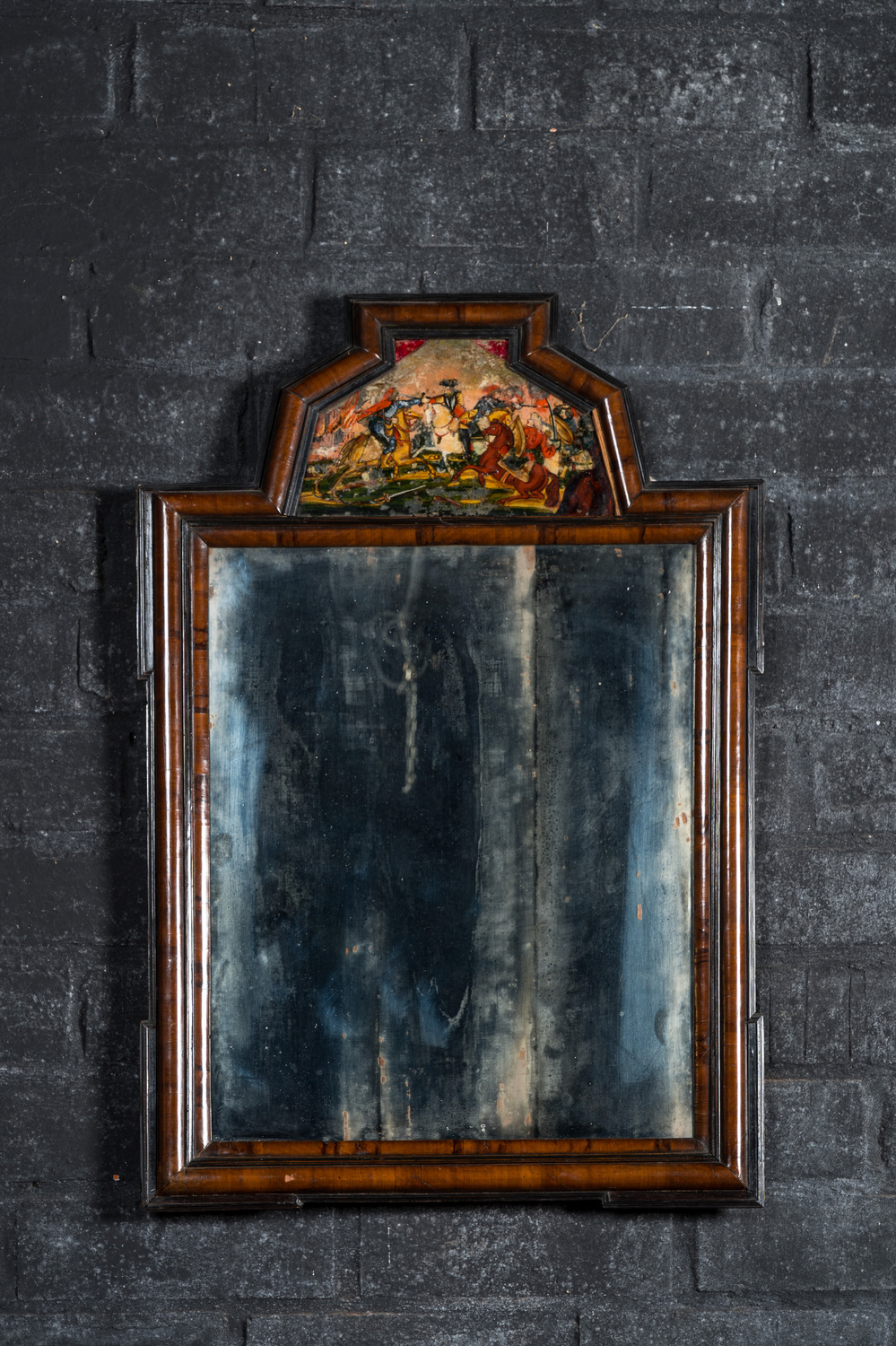 A Dutch mahogany mirror with ebonised frames and a reverse glass painting, 19th C.