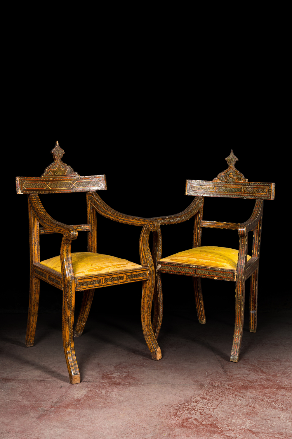 A pair of North African bone-inlaid wooden chairs with silk upholstery, 19th C